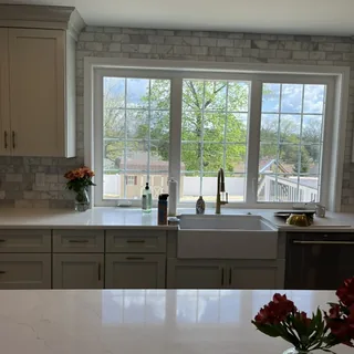 Custom kitchen cabinetry with quartz countertops and farmhouse sink