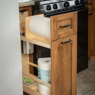 Pull-out paper towel and cleaning supply cabinet