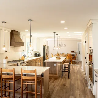 Custom white kitchen cabinetry with dining island