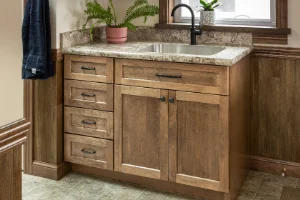 Using a professional level to prep bathroom cabinets for stone countertop installation in Chester County, PA