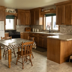 Custom Amish-built kitchen with granite countertop island and L-shaped cabinet layout in Willow Street, PA