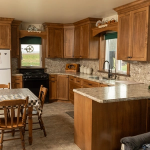 Custom wood cabinets with stone backsplash and granite countertops in Willow Street, PA kitchen