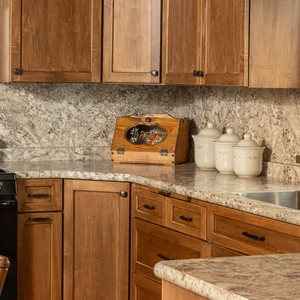 Corner counter with stone backsplash, gas range, and custom cabinetry in Willow Street, PA