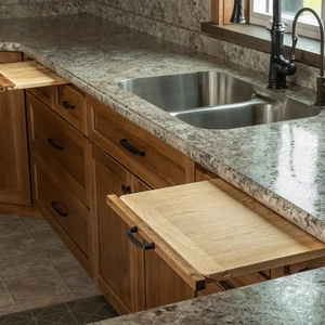 Pull-out cutting board extended beside undermount sink with granite countertop in Willow Street, PA