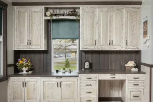 Amish cabinetmaker hand-finishing a solid hardwood cabinet in the Honey Brook shop